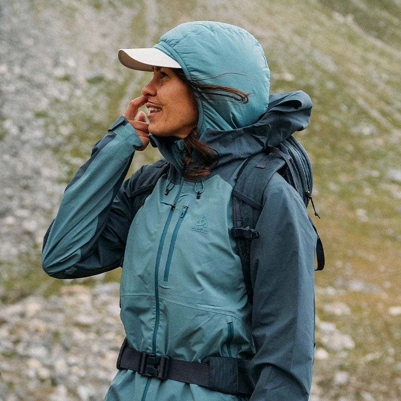 A woman wearing a hiking jacket