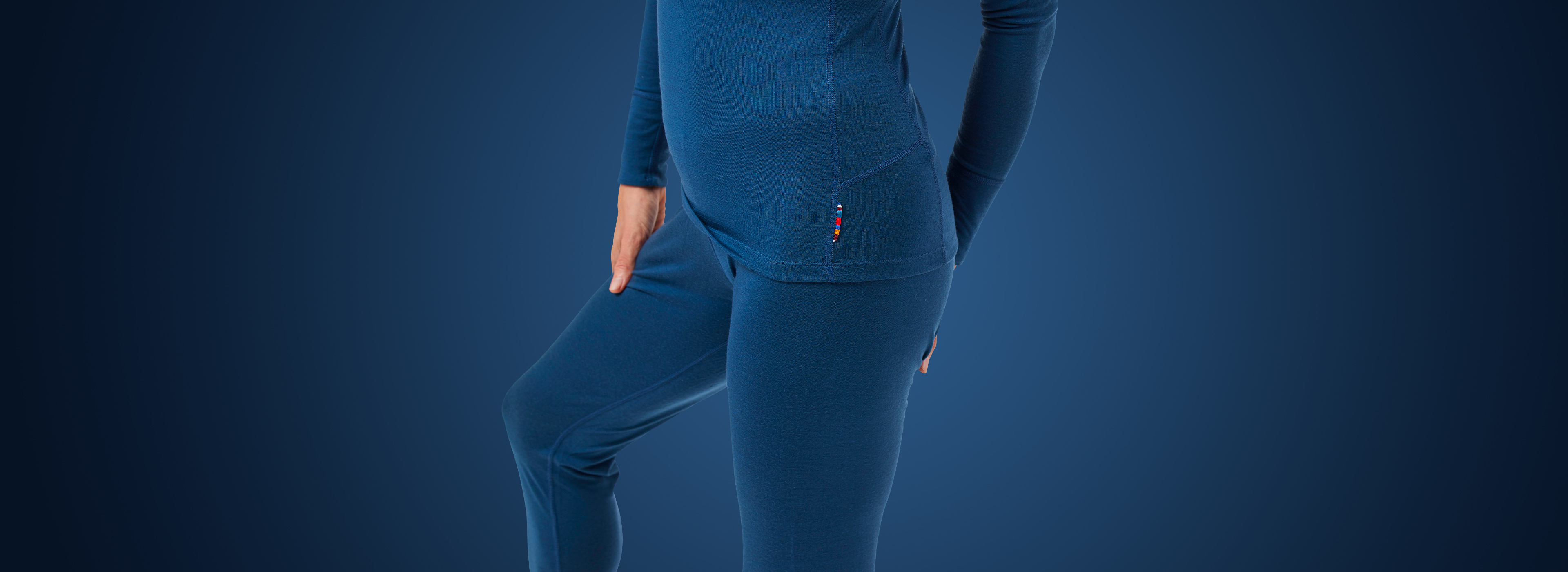 A woman wearing light base layer outfit crafted with merino wool