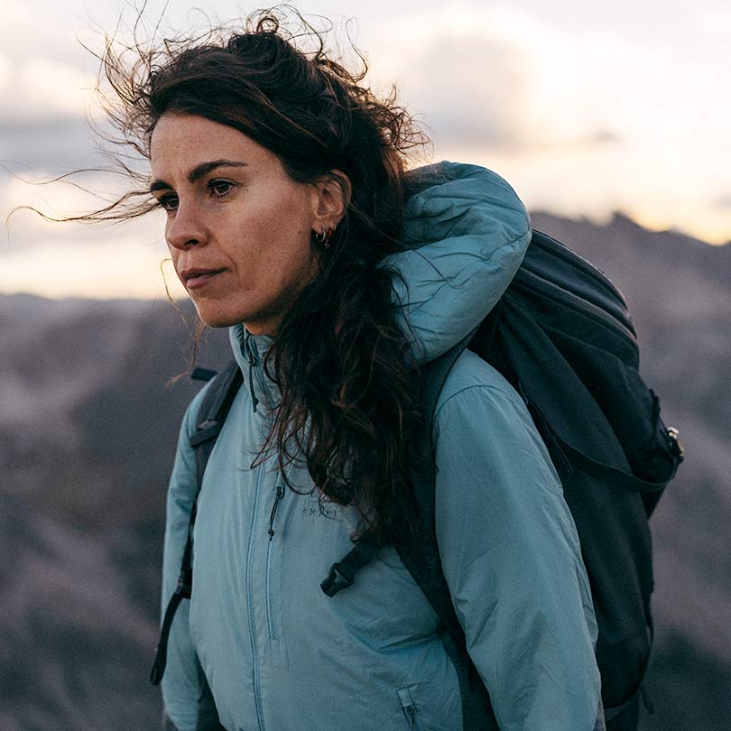 A woman wearing a hiking jacket