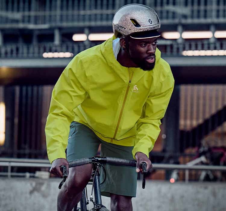 A man on a city bike wearing a waterproof cycling jacket