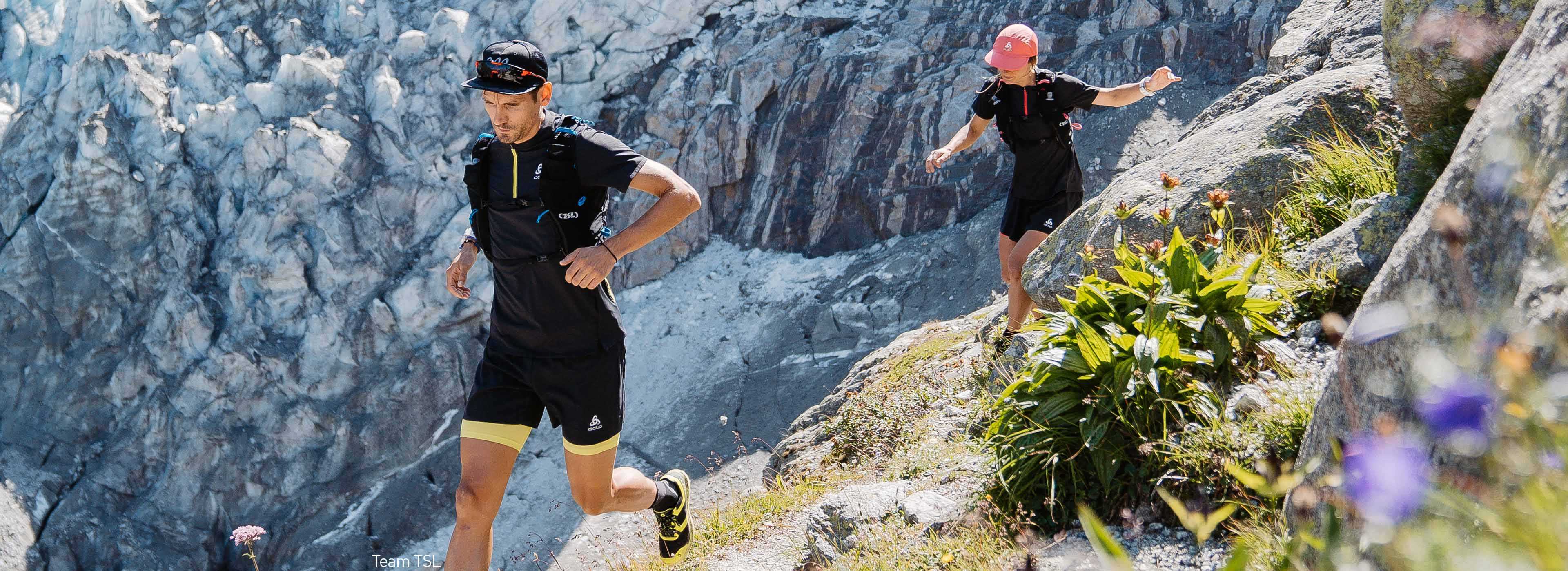 A couple of trail runners running in the Alps