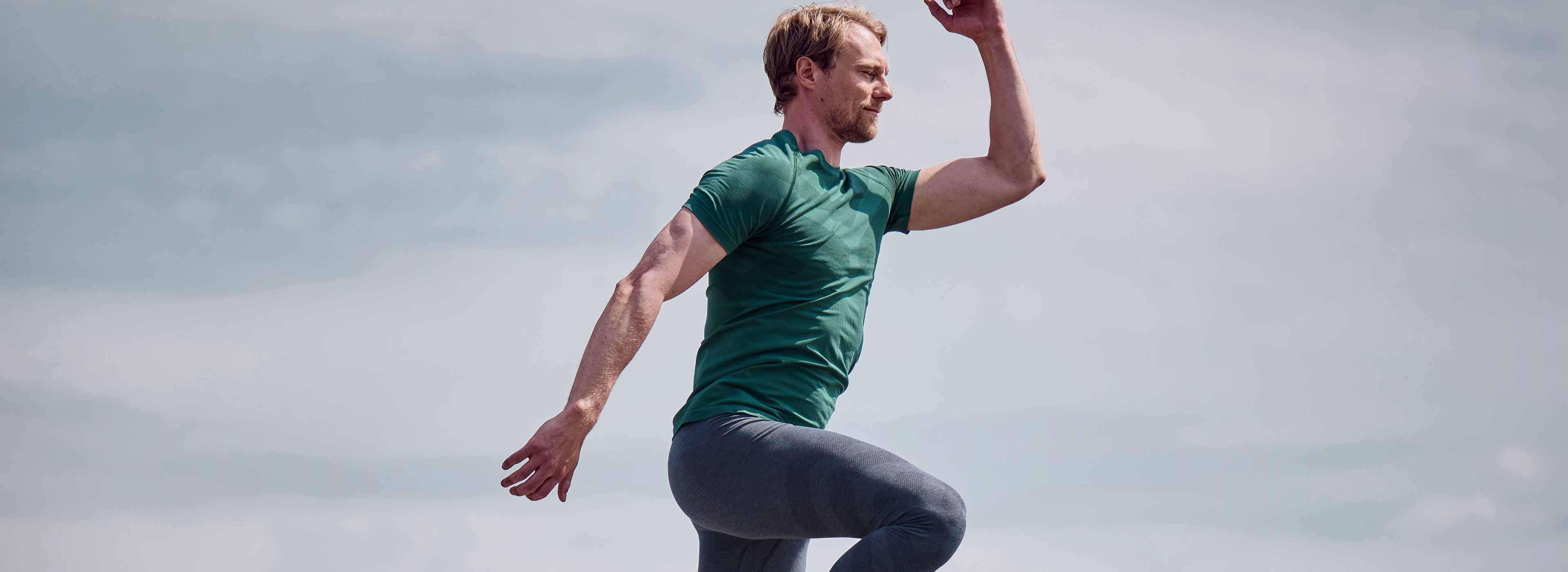 A man wearing light base layer outfit crafted with merino wool