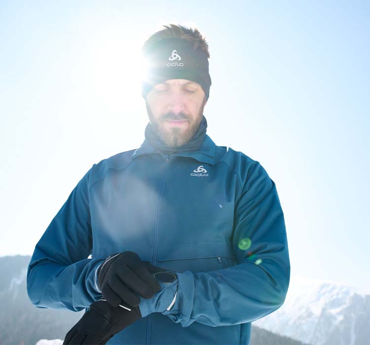 A close up of a man wearing a winter running outfit