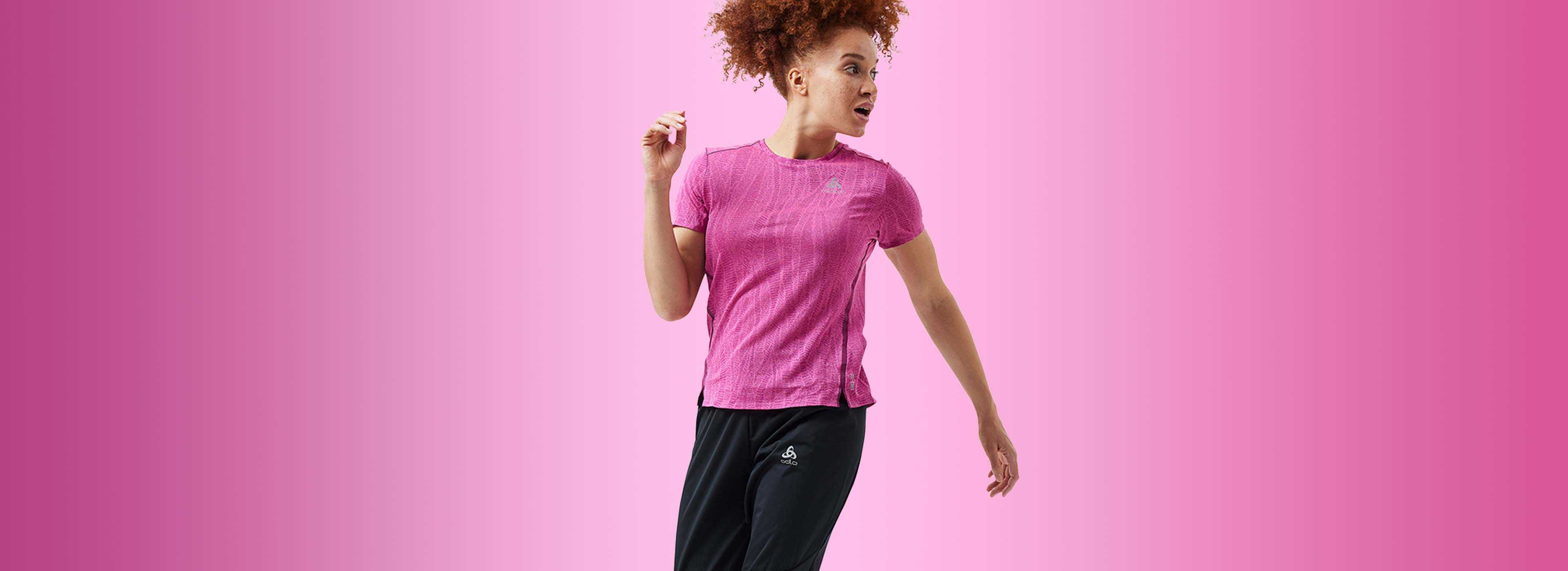 a woman wearing a light training outfit and jumping