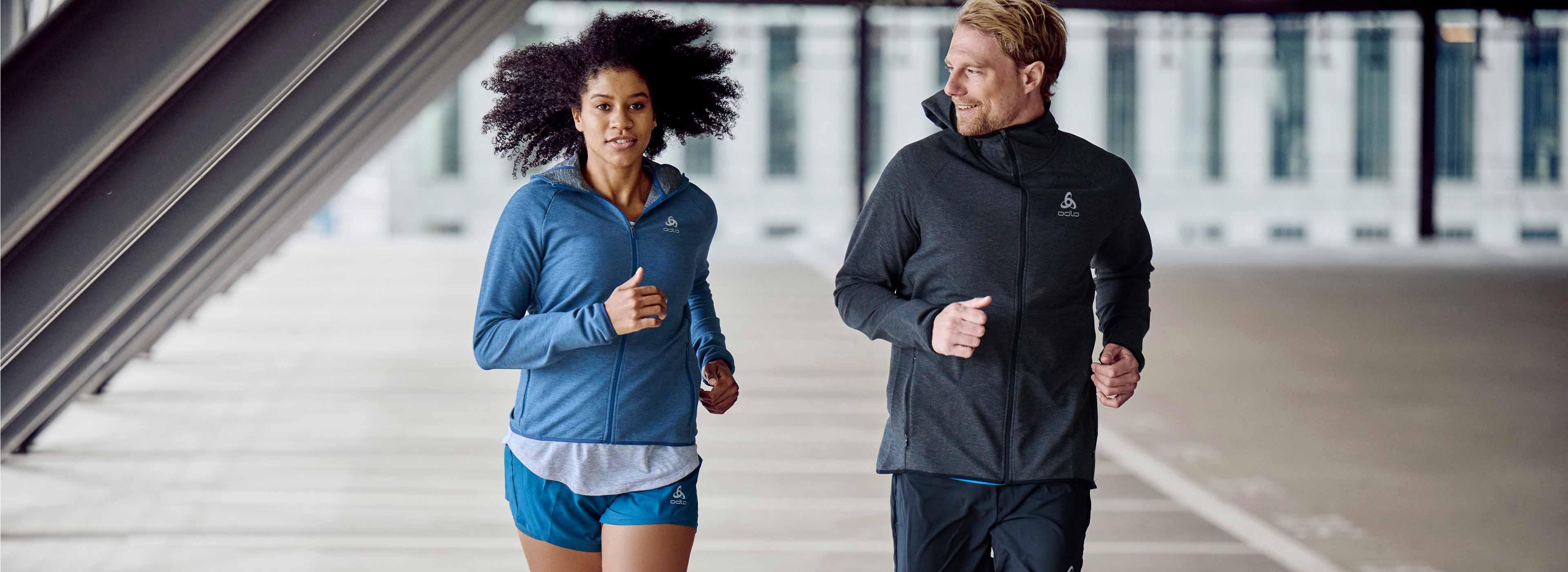 A couple wearing both a casual running hoodie