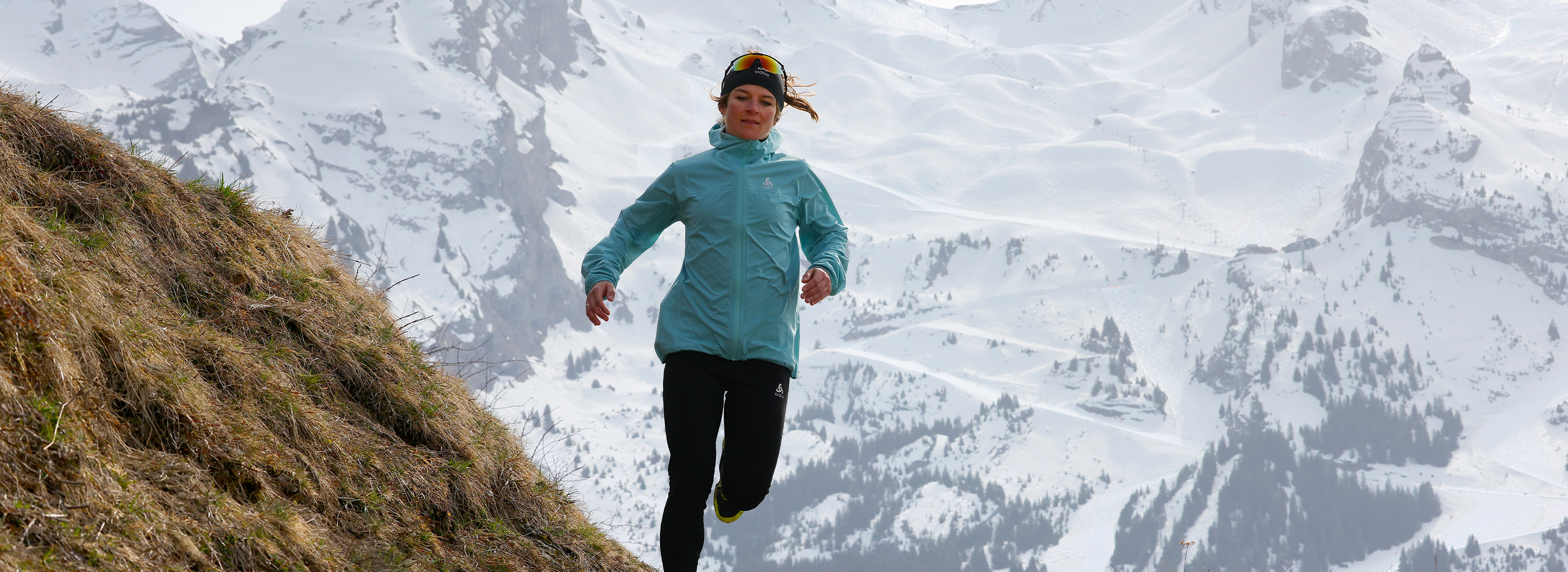 A female trail runner running in the Alps